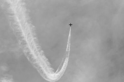 Low angle view of airplane flying in sky