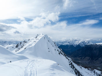 Scenic view of snowcapped mountains against sky