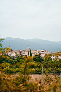 Buildings in town against sky