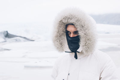 Portrait of man standing in snow