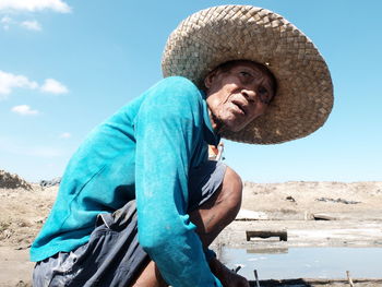 Portrait of woman against clear blue sky