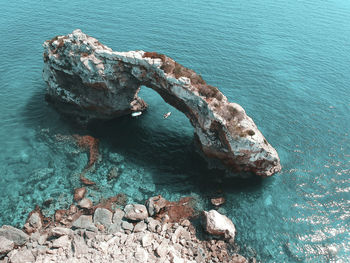 High angle view of rock formation in sea