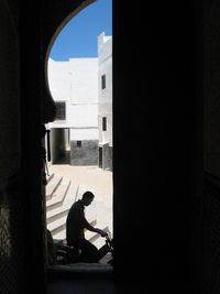 Side view of man sitting in building