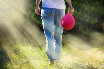 Low section of woman holding a balloon