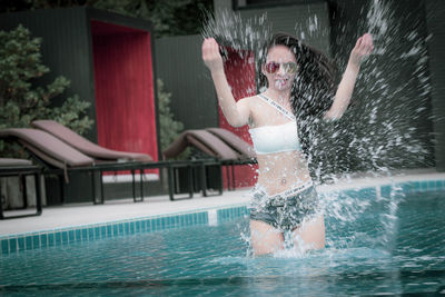 Man splashing in swimming pool