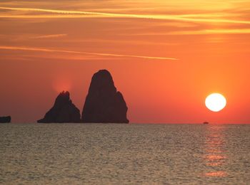 Scenic view of sea against romantic sky at sunset