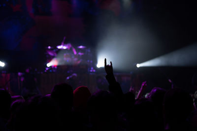 Concert crowd at an indoor event waits for headlining act to perform 