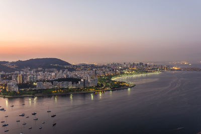 Illuminated city at waterfront