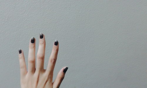 Close-up of hand against white background