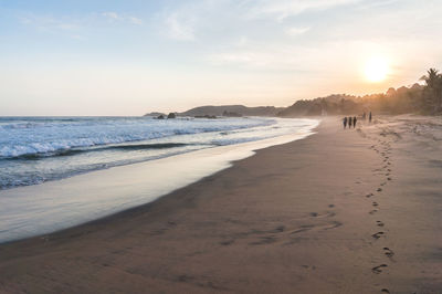 Scenic view of beach against sky during sunset