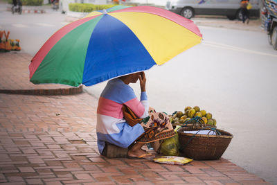 People holding umbrella on street during rainy season