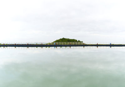 Bridge over lake against sky
