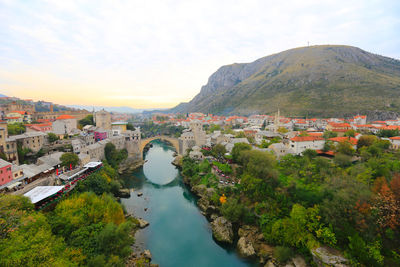 High angle view of river amidst buildings against sky