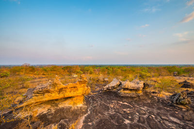 Scenic view of land against sky during sunset