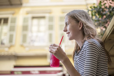 Portrait of a smiling young woman looking away