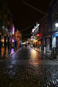 Illuminated street lights in city at night