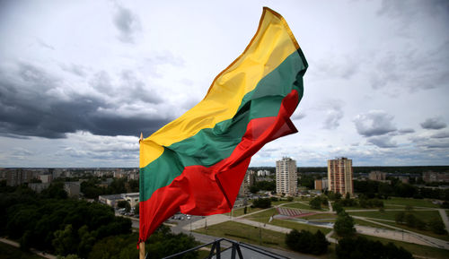 Flag against sky in city