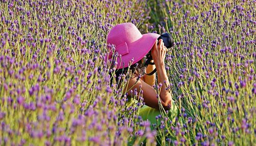 Low angle view of woman with umbrella on field