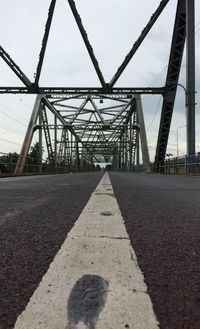 Surface level of bridge against sky in city