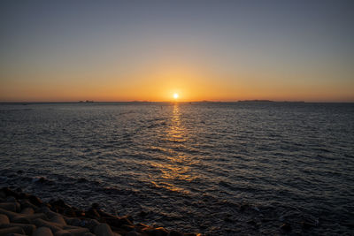 Scenic view of sea against orange sky