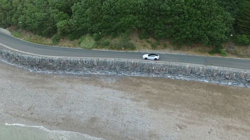 High angle view of car on road against trees