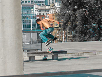 Full length of man skateboarding in city