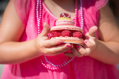 Midsection of girl holding sweet food