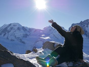 Scenic view of snowcapped mountains on sunny day