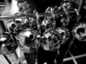 Close-up of metallic bells hanging on railing