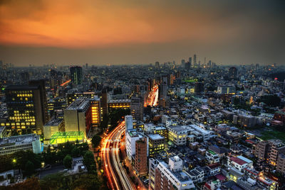 High angle view of illuminated city buildings at night