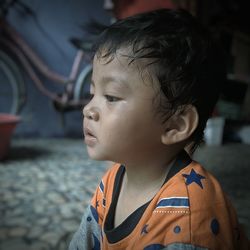 Close-up portrait of cute boy looking away