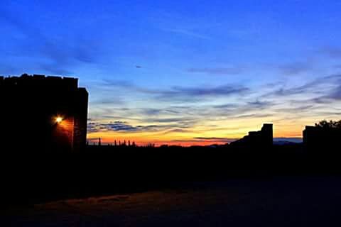 silhouette, sunset, sky, orange color, dark, scenics, beauty in nature, built structure, building exterior, tranquility, architecture, tranquil scene, cloud - sky, dramatic sky, outline, nature, copy space, cloud, dusk, idyllic