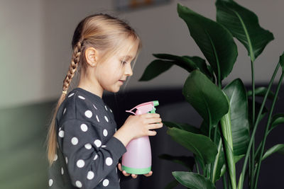 Young woman holding plant