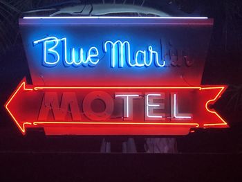 Close-up of illuminated text on wall at night