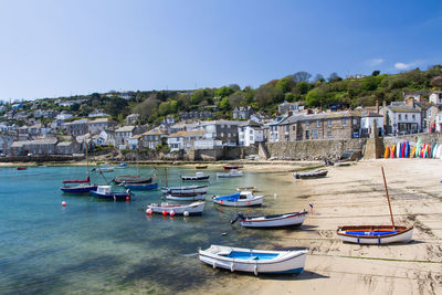 Boats moored at beach in mousehole