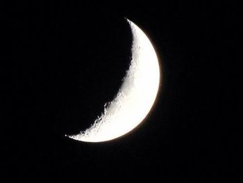 Low angle view of moon over black background