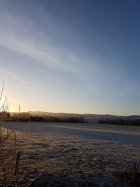 Scenic view of lake against sky during winter