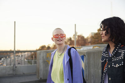 Smiling young women walking together and talking