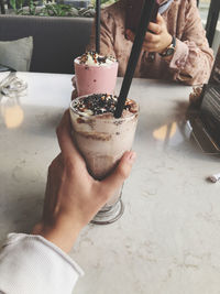 Midsection of man holding ice cream cone