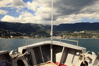 Scenic view of sea and mountains against sky