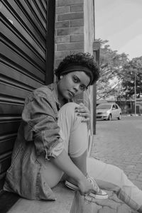 Portrait of young woman sitting outdoors