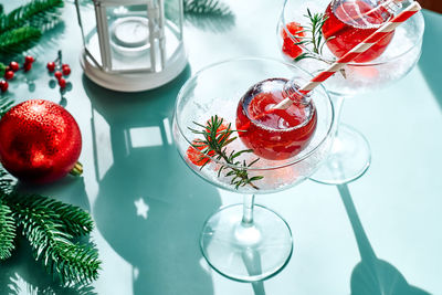 Christmas drink mimosa, punch or margarita cocktail serving in christmas ornaments.