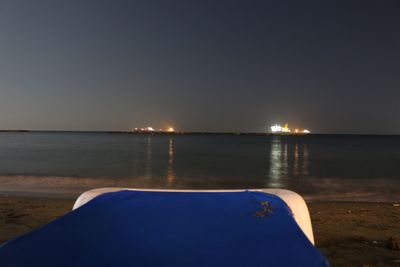 Scenic view of sea against clear blue sky at night