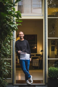 Portrait of male architect standing in house doorway