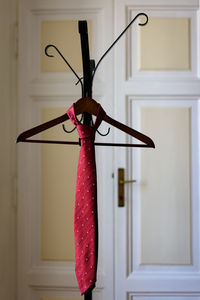 Close-up of red bell hanging at home