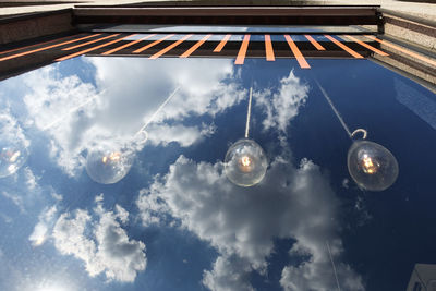 Low angle view of reflection of clouds in sky