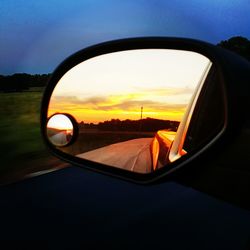 Reflection of car on road at sunset