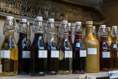 Close-up of drinks in glass bottles on shelf