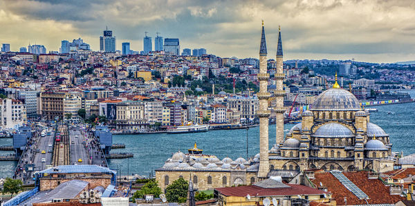 Panoramic view of buildings in city against sky