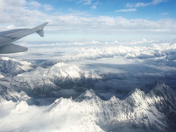 Aerial view of snowcapped mountains against sky